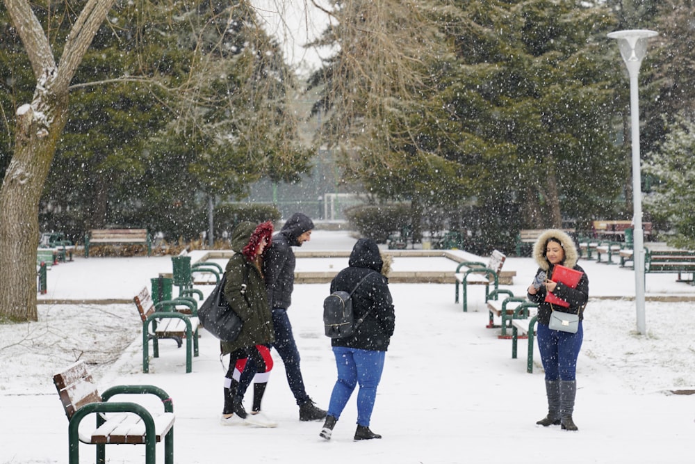 people walking on snow covered ground during daytime