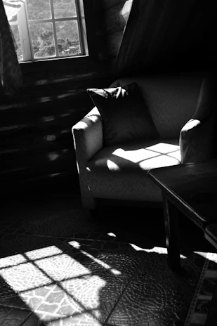 Cozy fabric single armchair in a softly lit living room setting