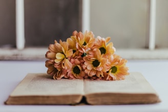 yellow flowers on brown wooden table