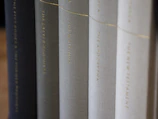 Elegant law books with black covers and gold lettering on a dark shelf.