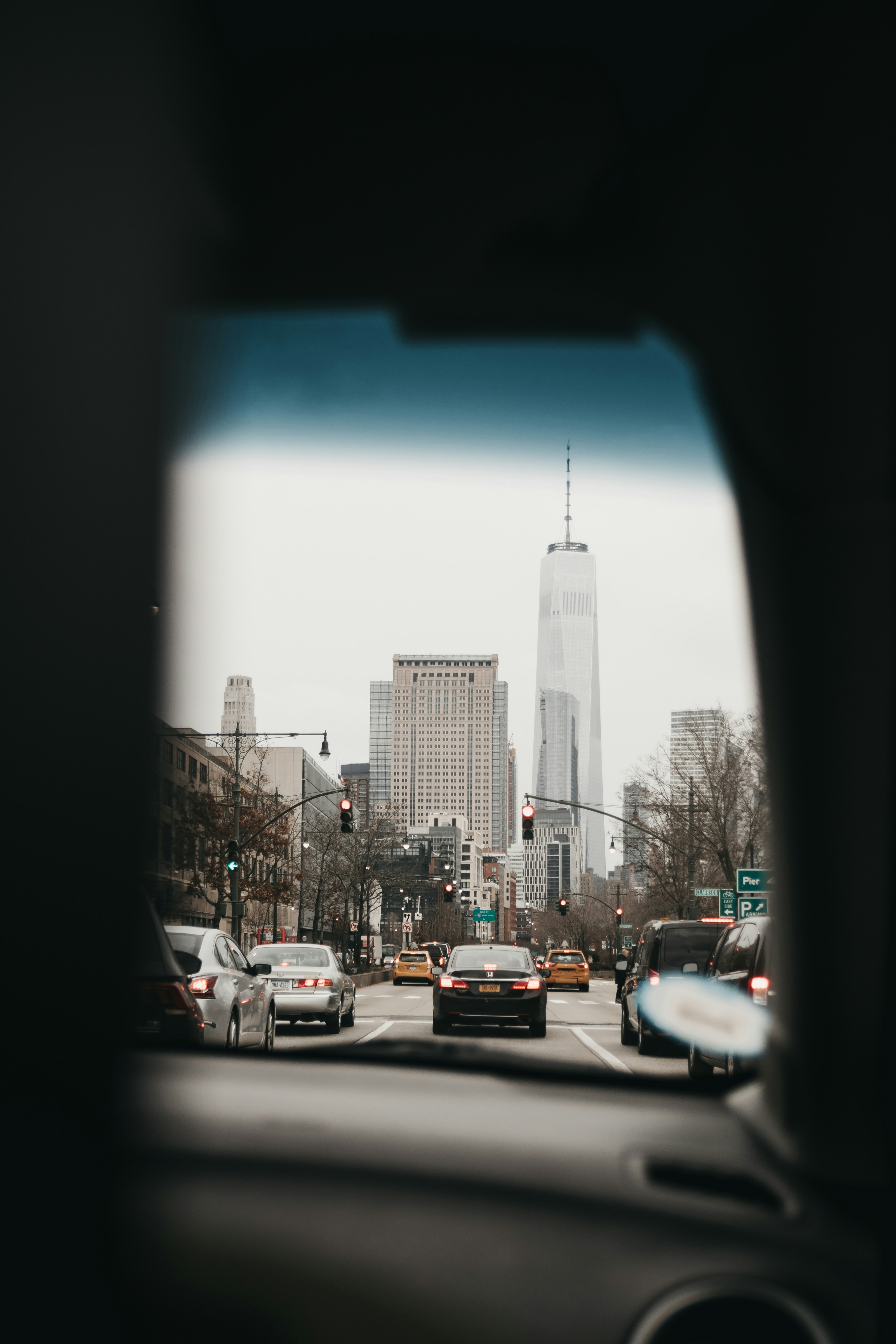 cars on road near high rise buildings during daytime