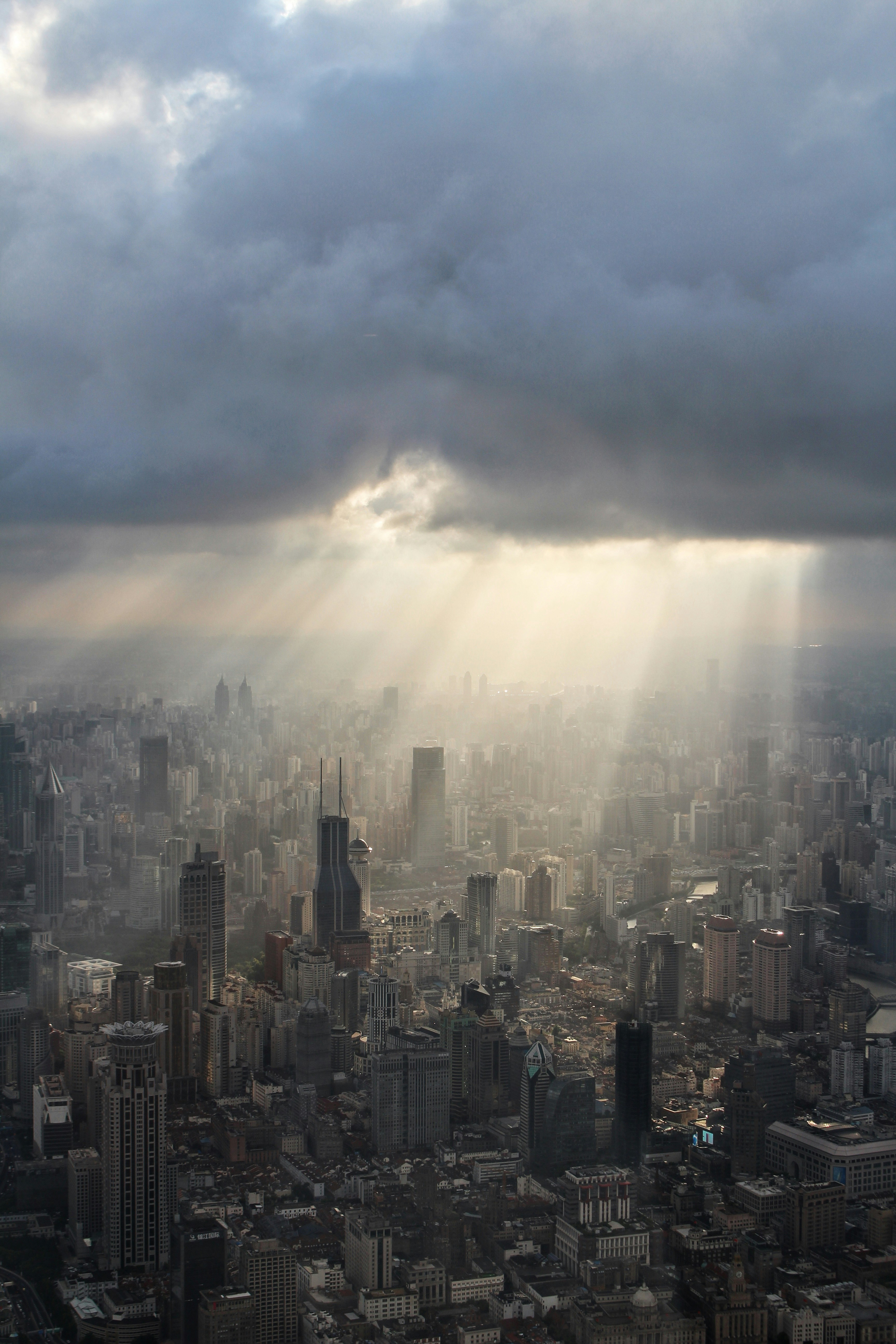 high rise buildings under white clouds during daytime