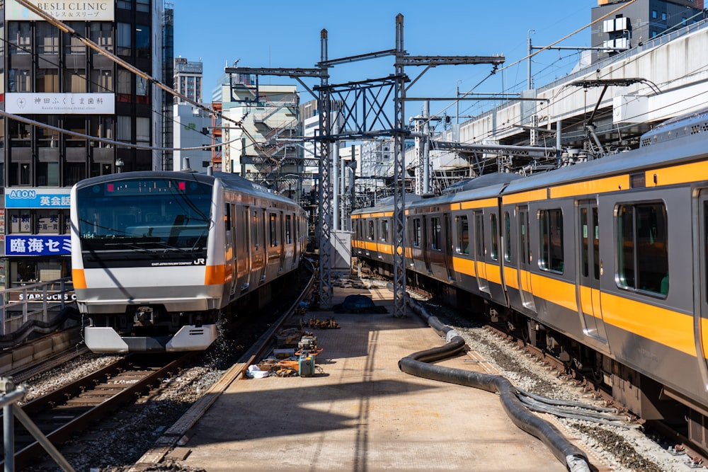 yellow and green train on rail tracks during daytime