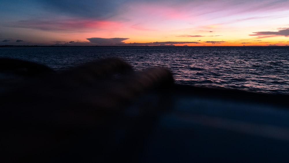 body of water during sunset