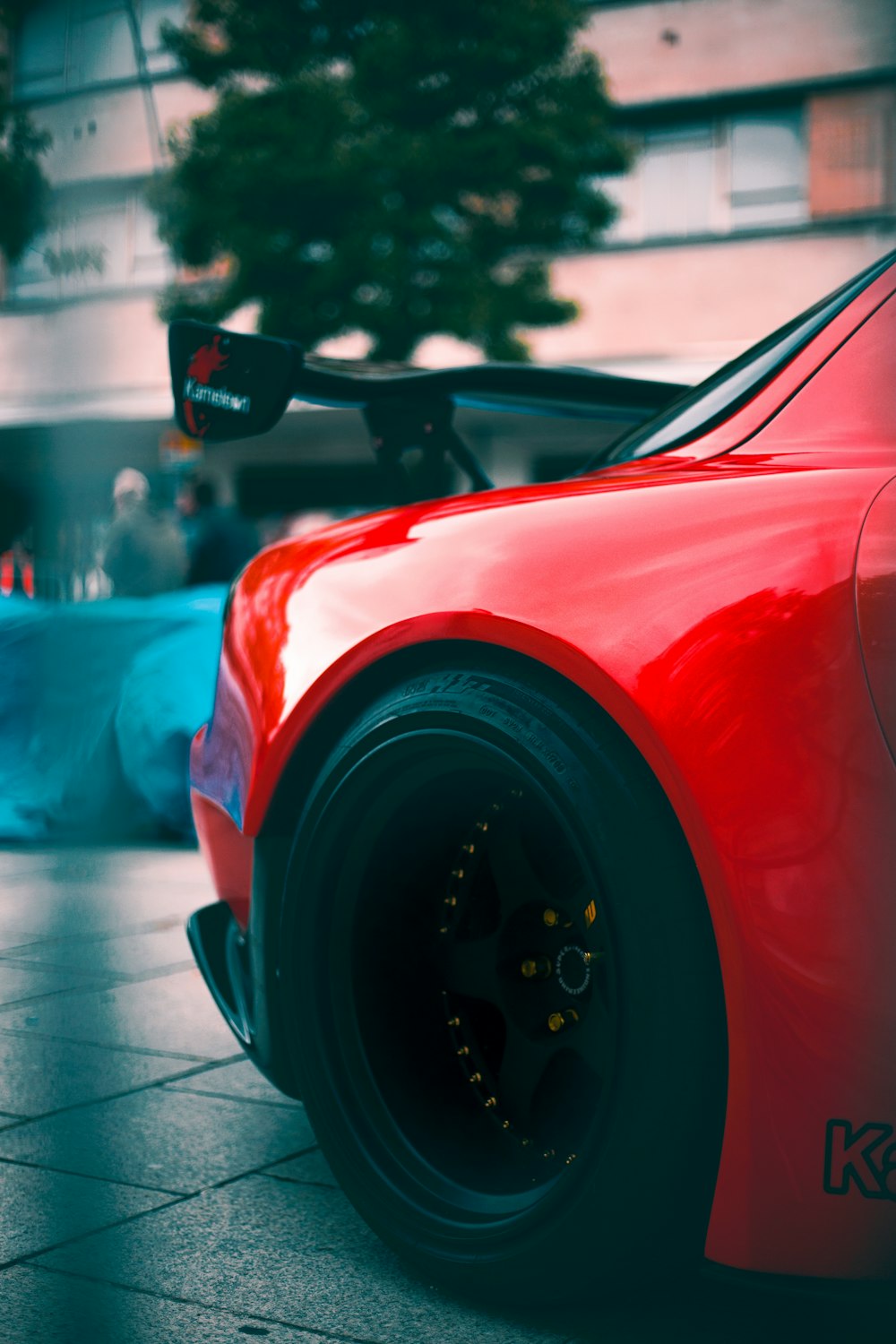 red car on the street during daytime