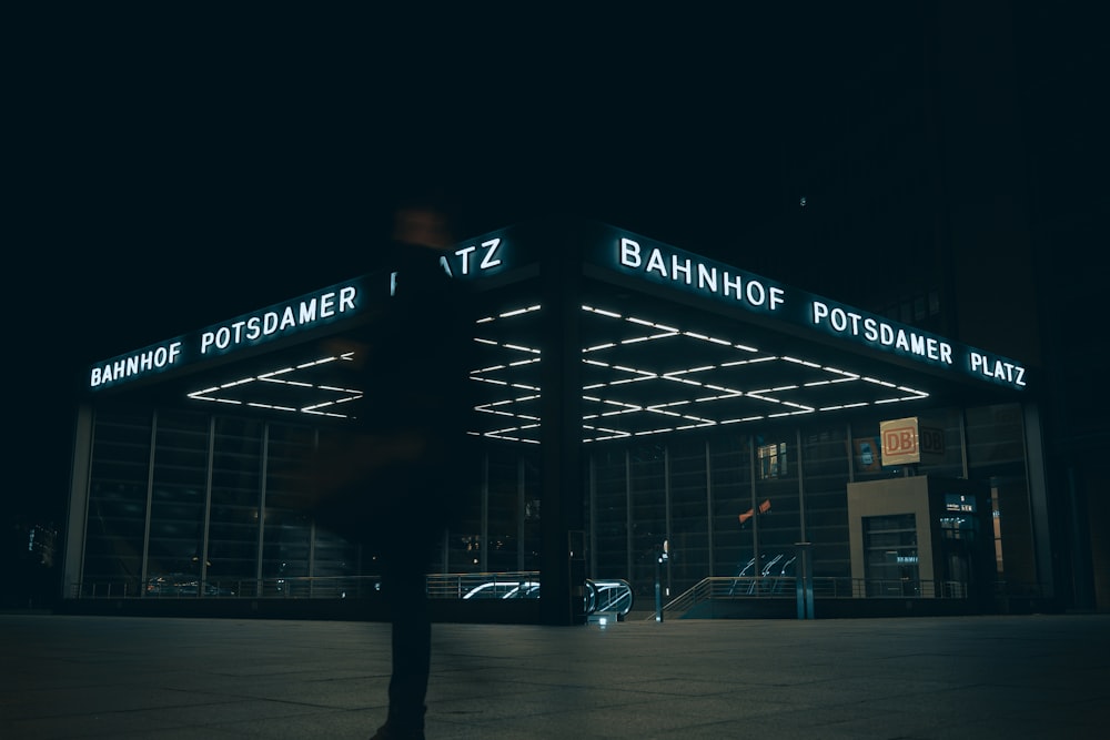 a person standing in front of a building at night