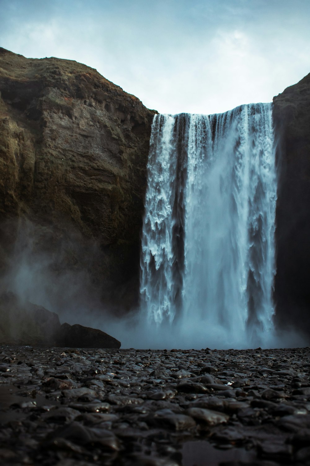 waterfalls on rocky mountain during daytime