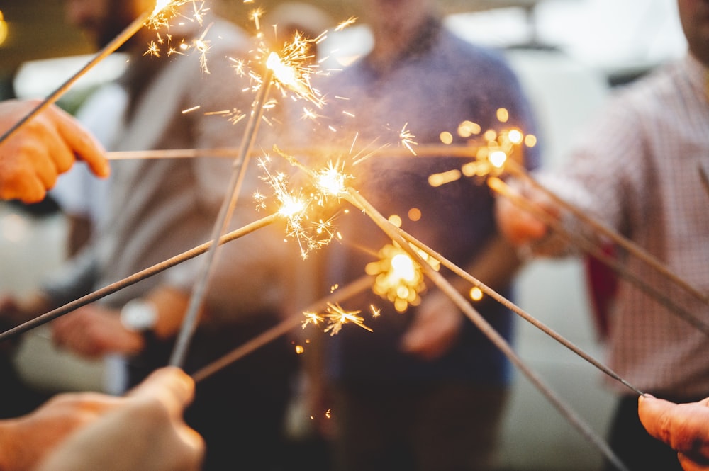 man in black crew neck t-shirt holding sparkler