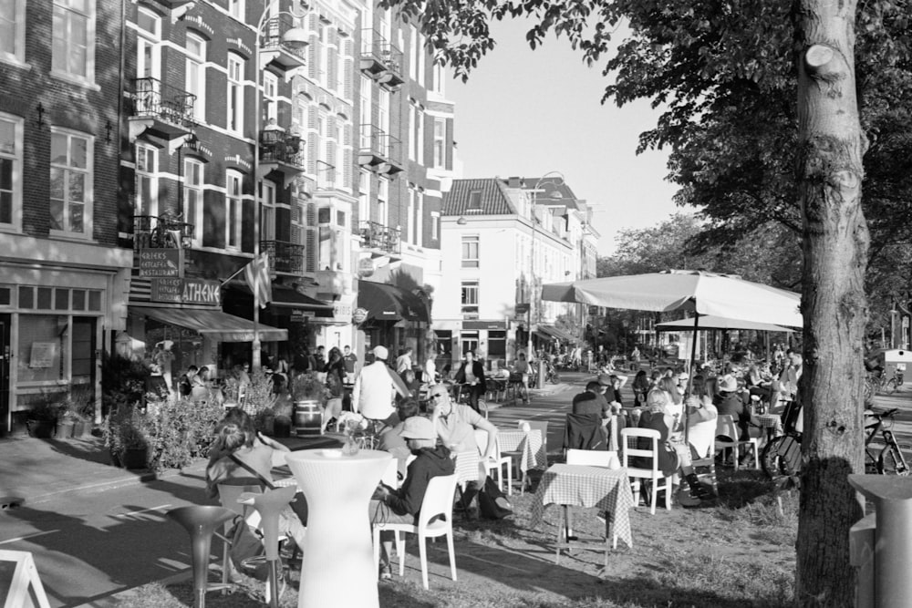 grayscale photo of people sitting on chairs