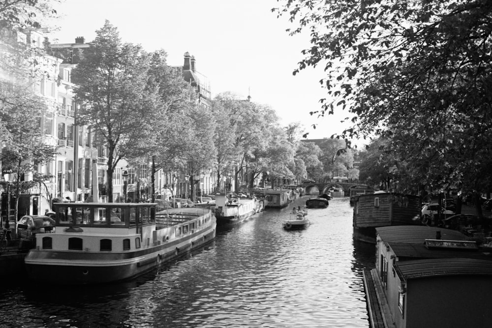 grayscale photo of boat on river