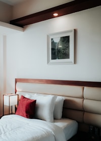 Stylish Airbnb bedroom with clean lines, fresh linens, and colorful decorative touches.