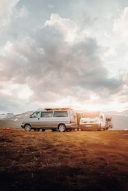 silver suv on brown field under white cloudy sky during daytime