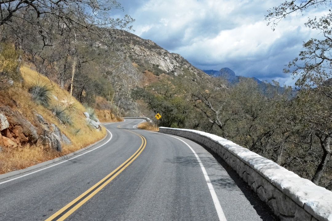 yellow car on road near mountain during daytime