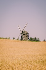 windmill on brown grass field during daytime