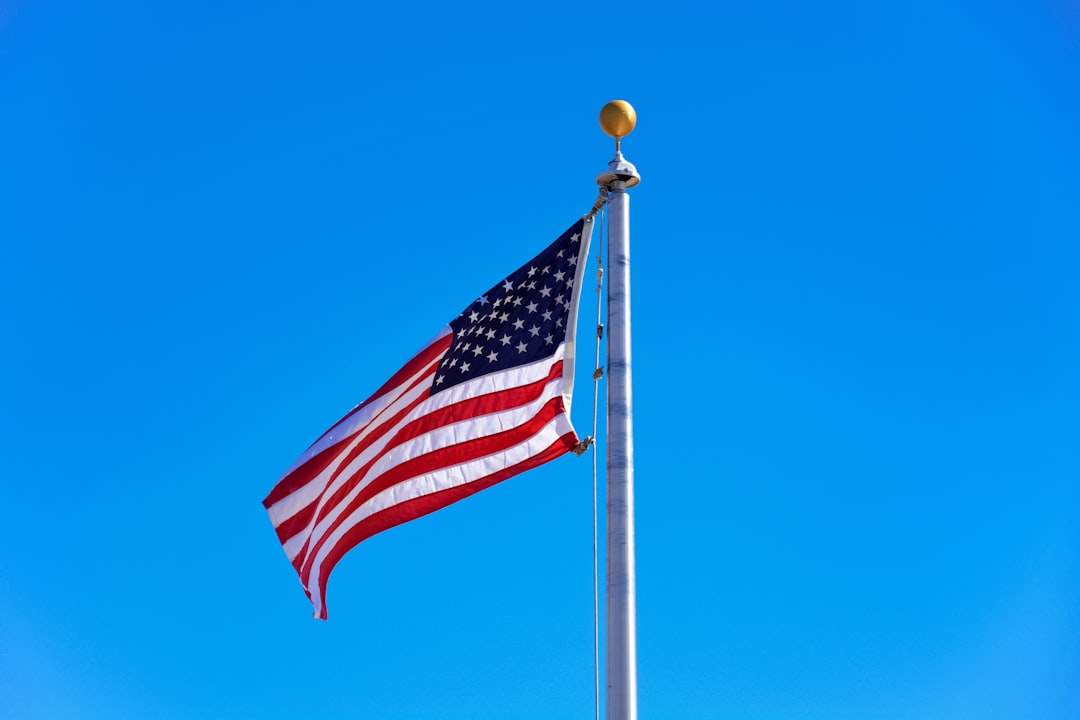 us a flag on pole during daytime