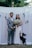 man in gray suit jacket holding woman in white wedding dress