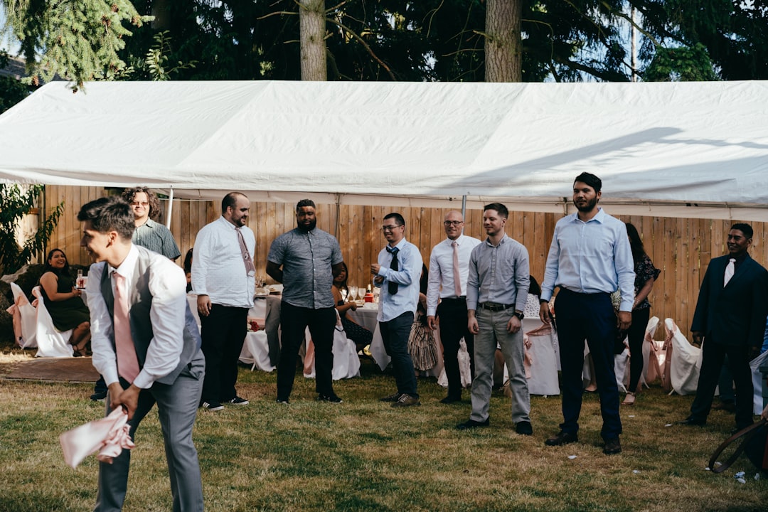 group of people standing on green grass field during daytime