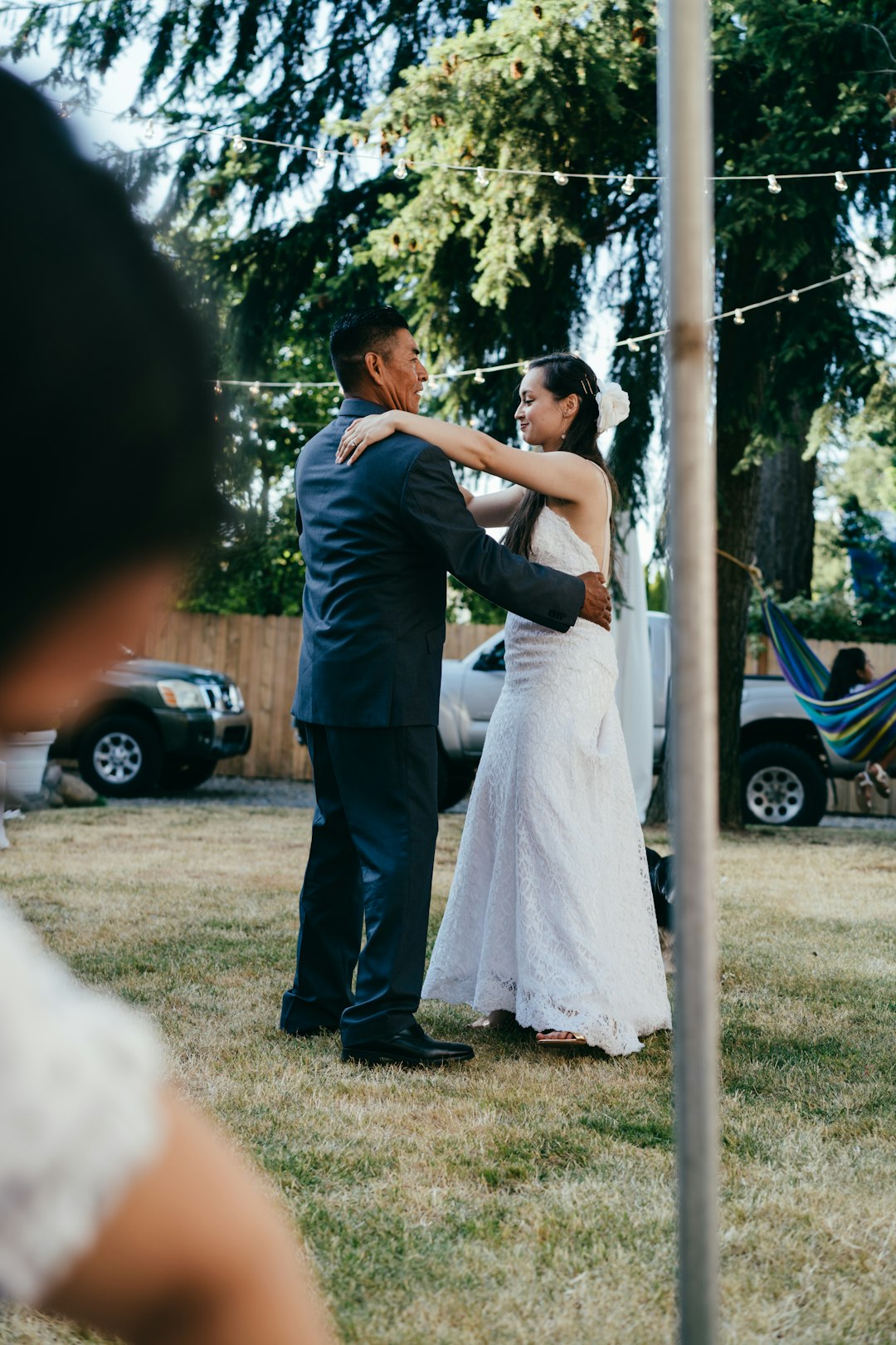 man and woman kissing on green grass field during daytime