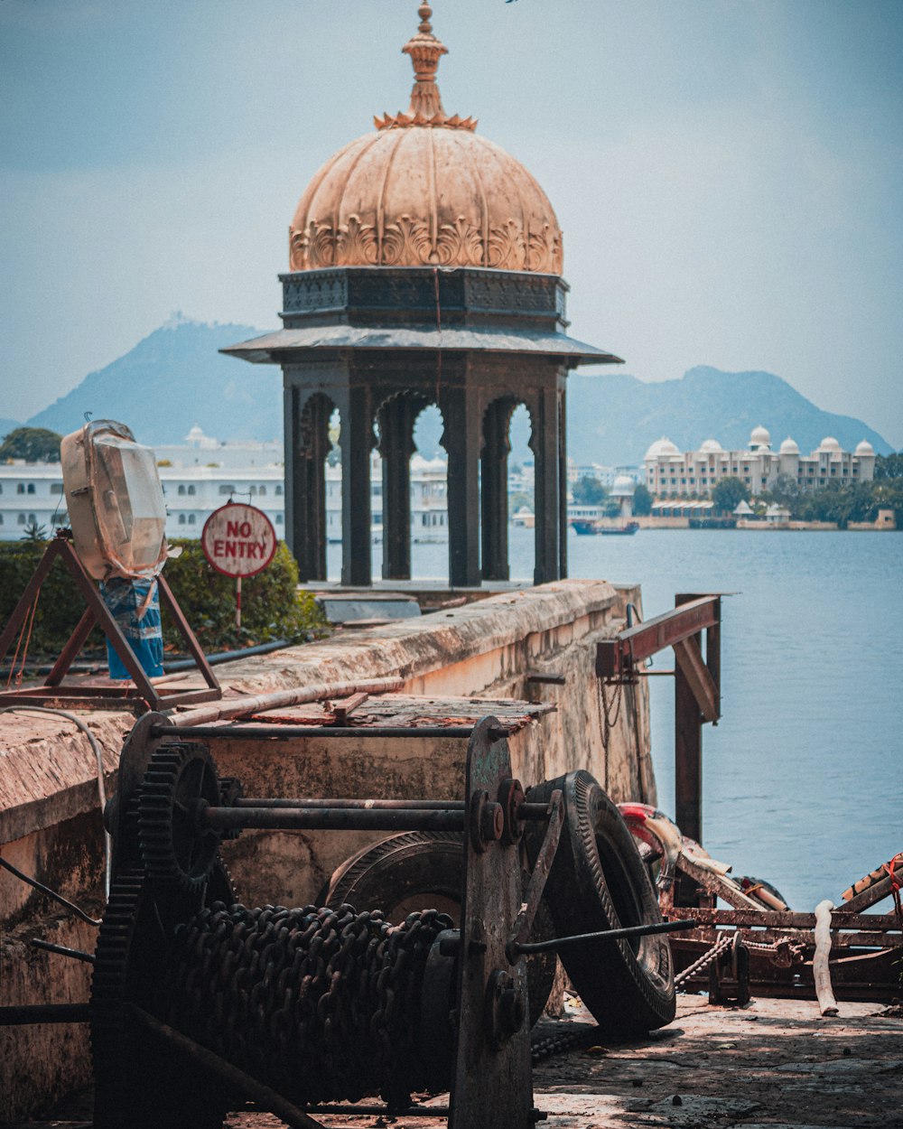 brown wooden boat on sea dock near brown and green dome building during daytime