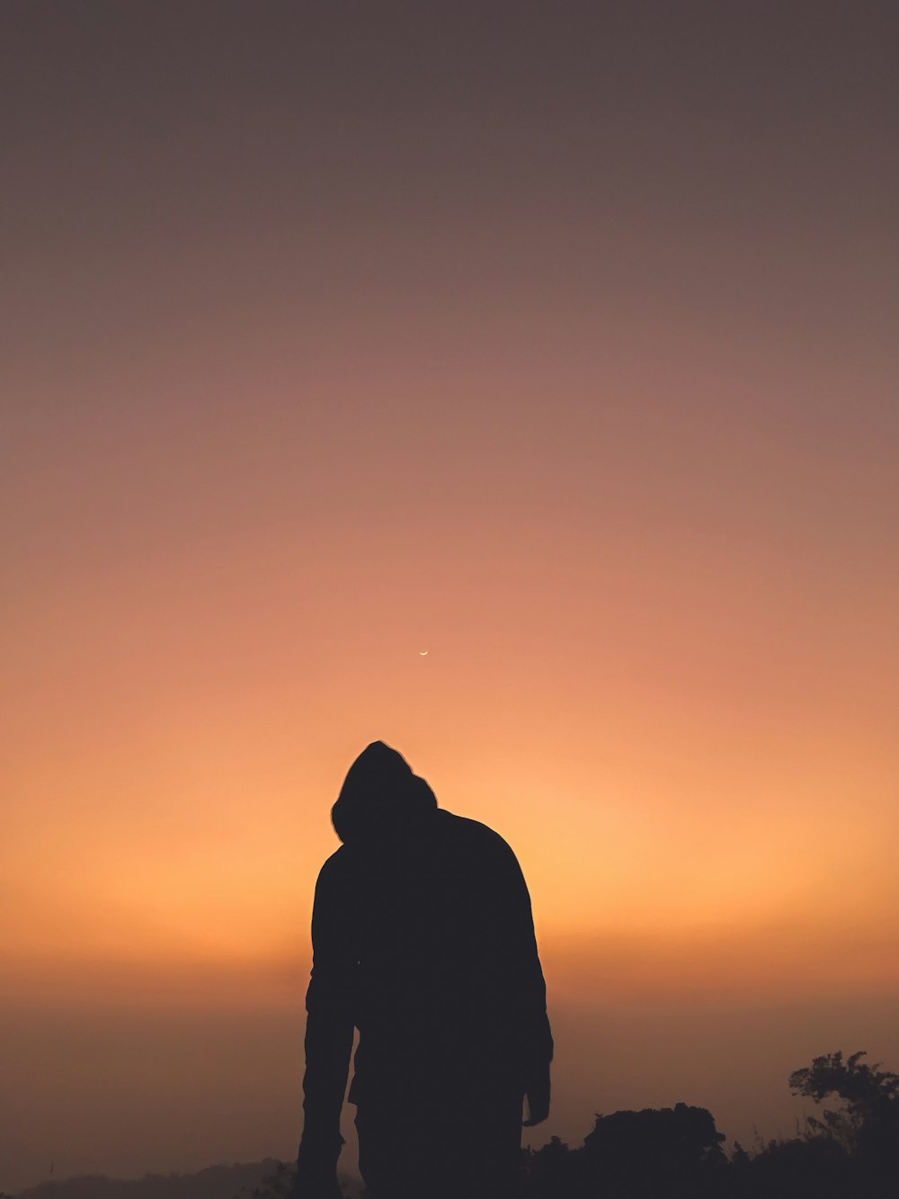 silhouette of person standing during sunset
