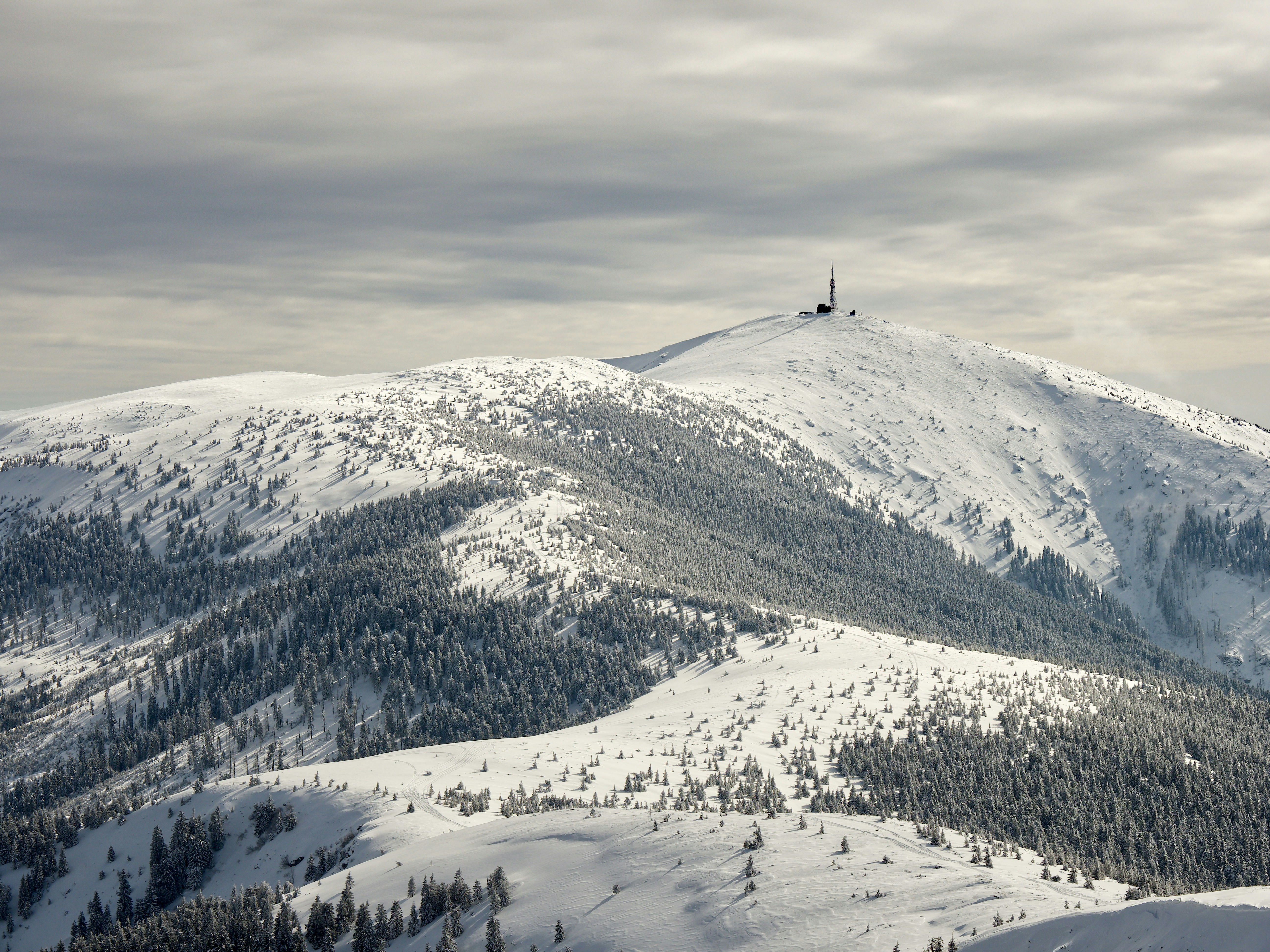 snow covered mountain under cloudy sky during daytime
