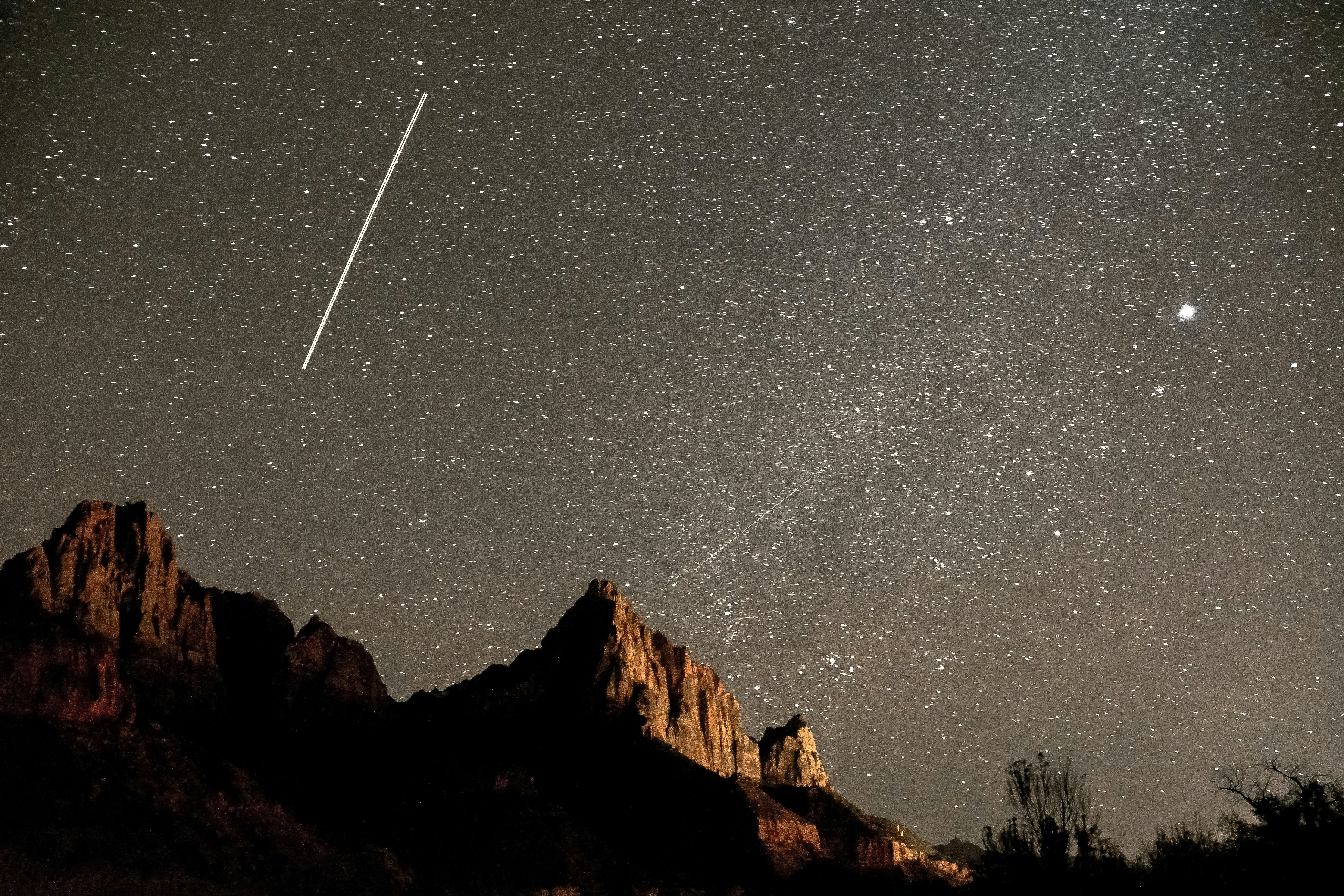 brown rocky mountain under starry night