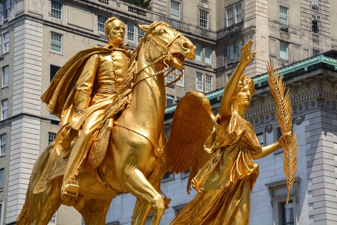 gold statue of man and woman