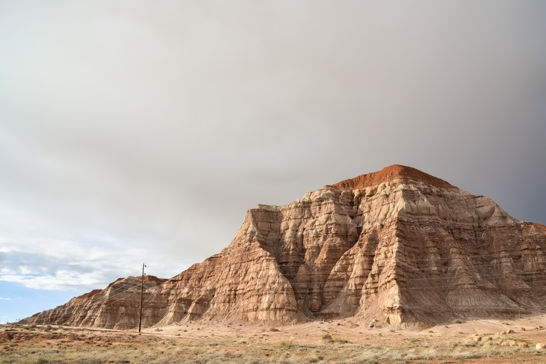 brown rock formation under white sky during daytime