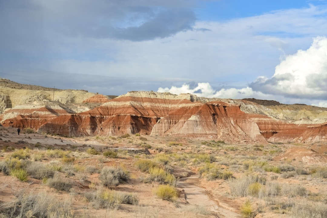 brown rock formation under white clouds during daytime