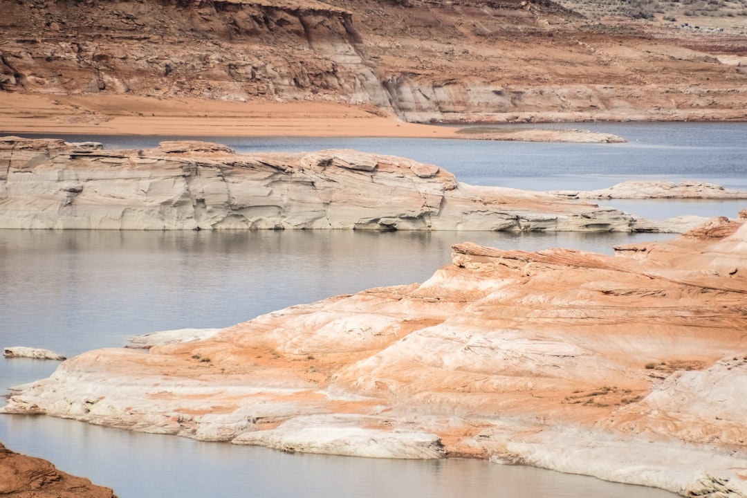 brown rock formation near body of water during daytime