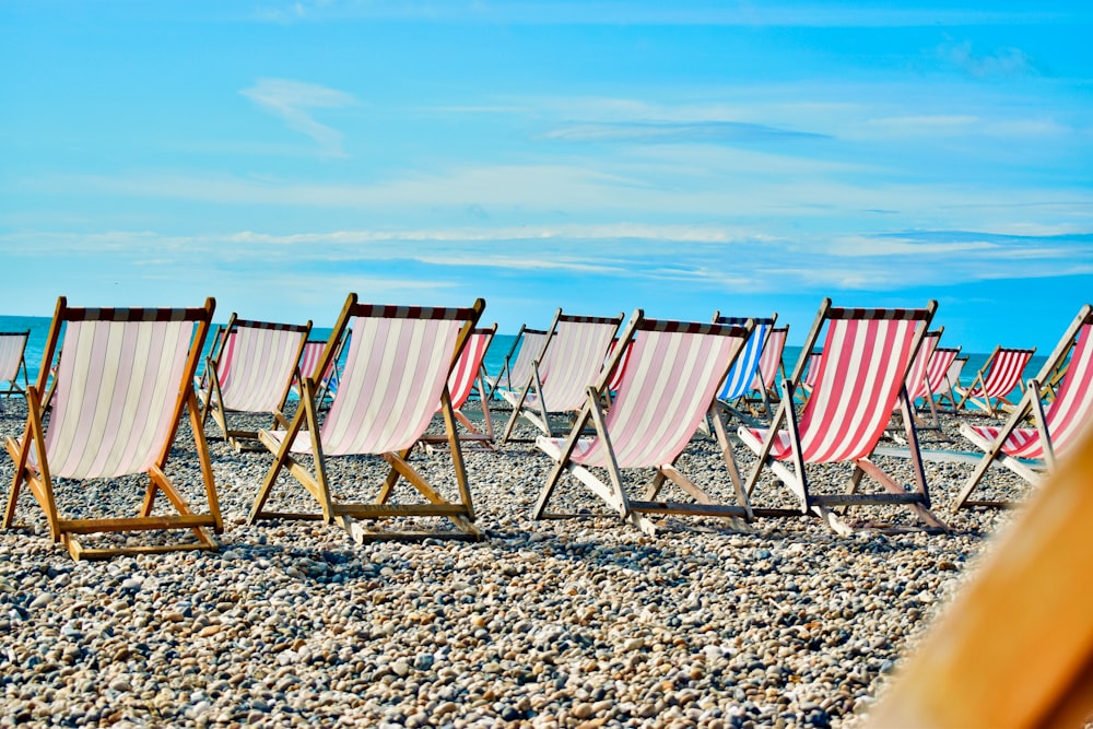 brown wooden folding chairs on beach during daytime