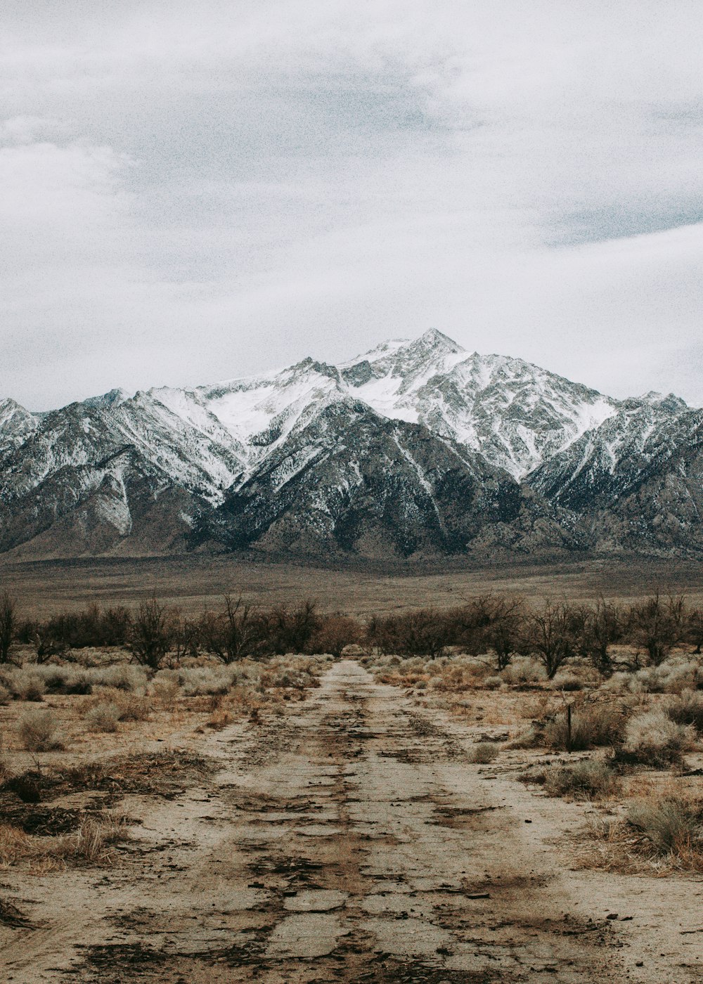 snow covered mountains under cloudy sky during daytime