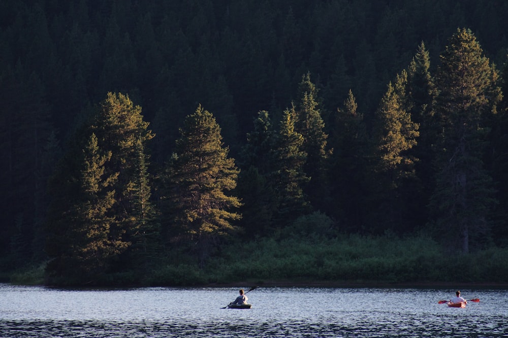 person riding on boat on lake during daytime