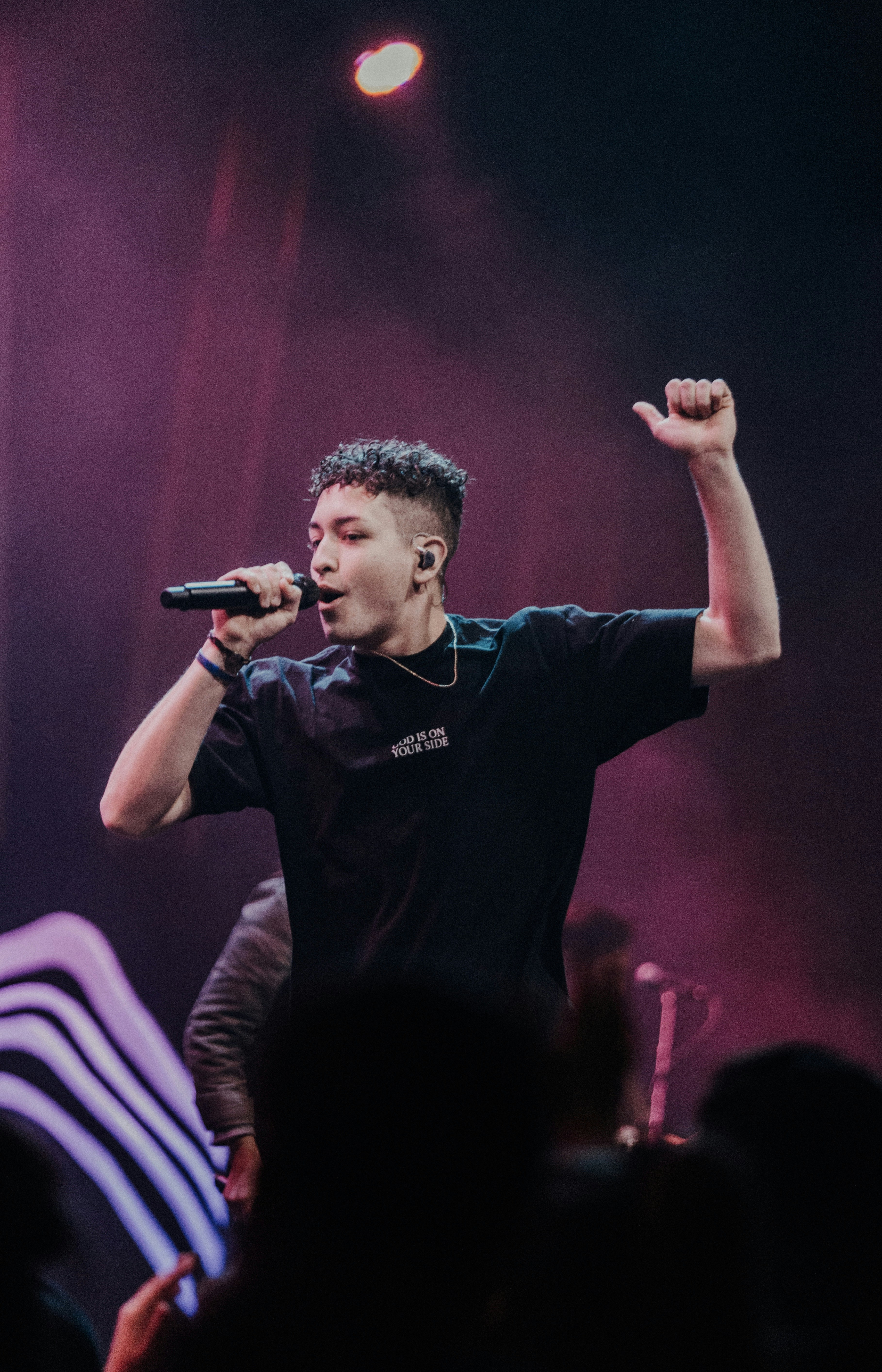 A close-up of a vintage microphone in a softly lit room.