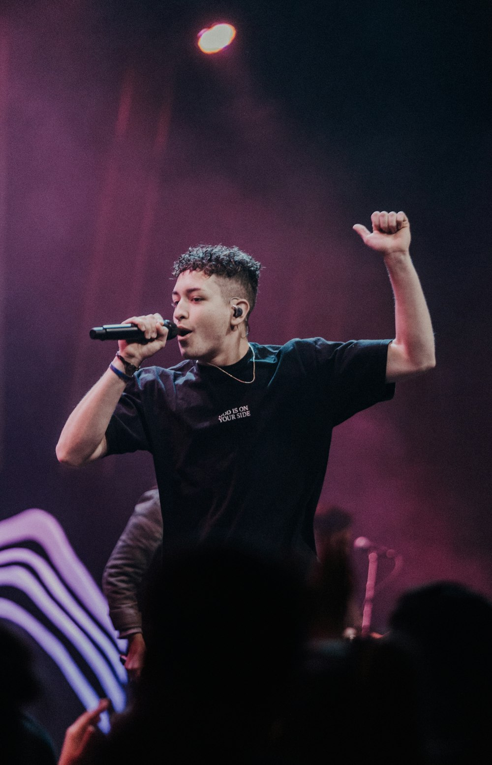 a man standing on a stage holding a microphone