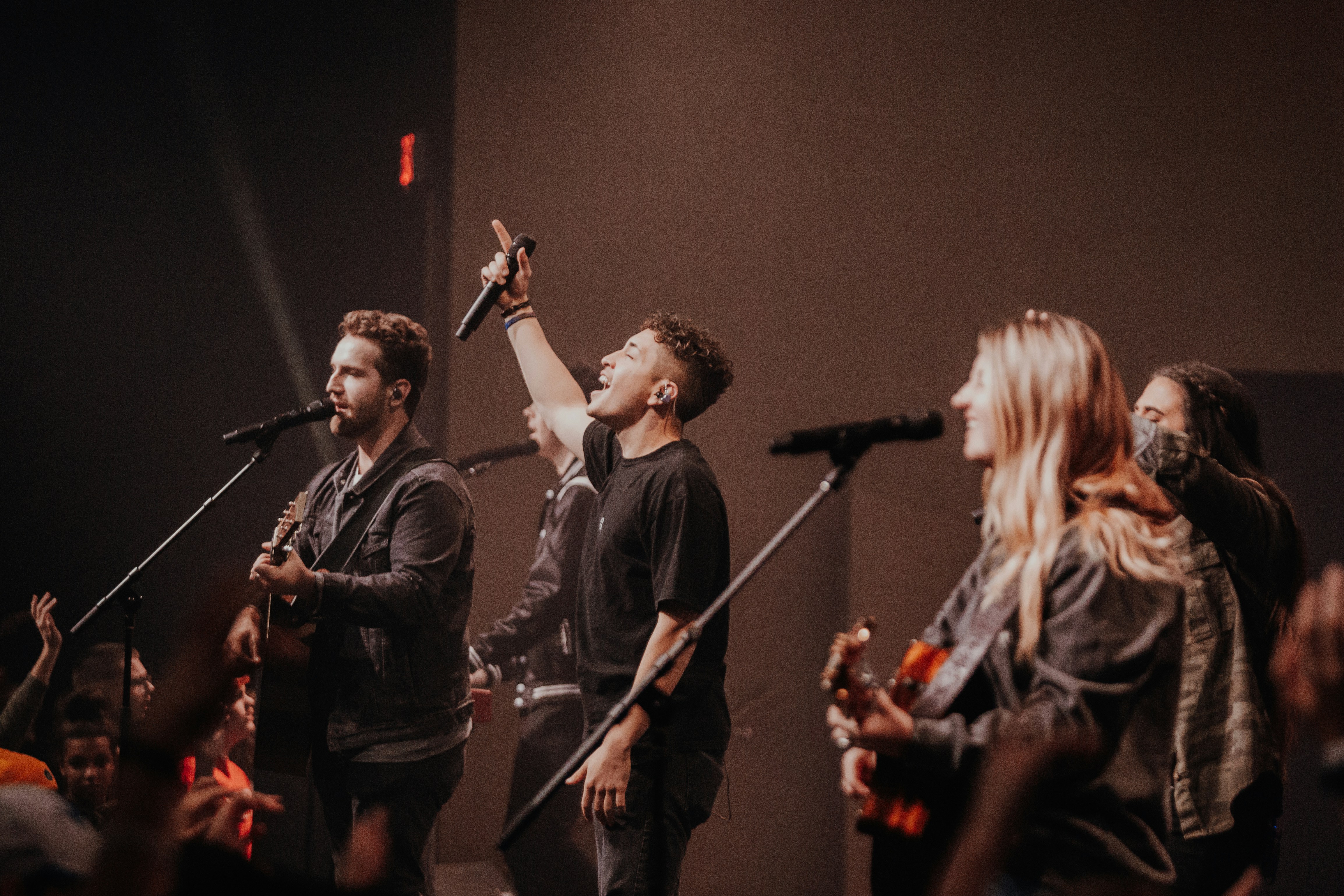 a group of people standing on a stage with microphones