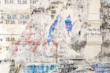 A close-up of a weathered calendar page torn from yesterday.
