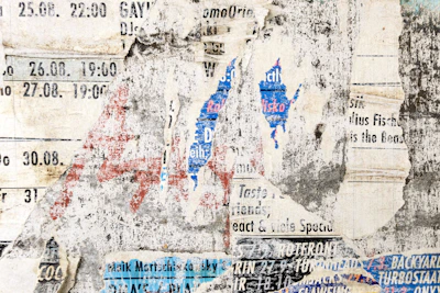 A close-up of a weathered calendar page torn from yesterday.