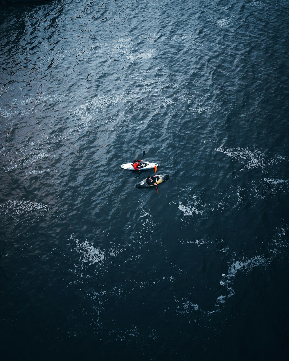 white and red boat on blue sea during daytime