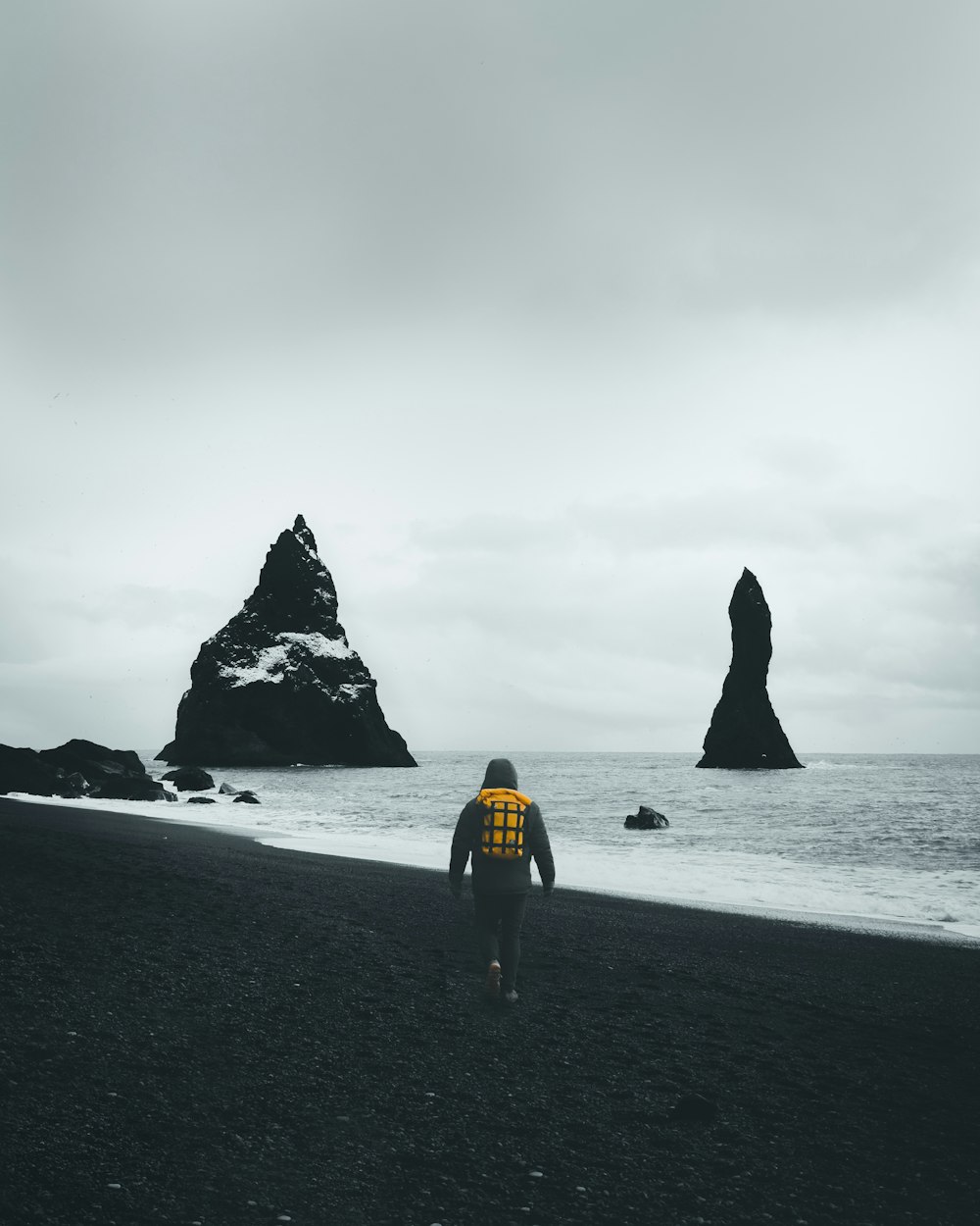 woman in yellow shirt walking on beach during daytime