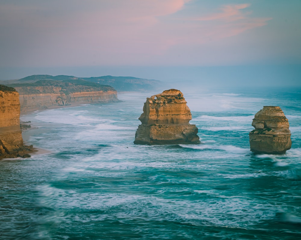 brown rock formation on sea during daytime