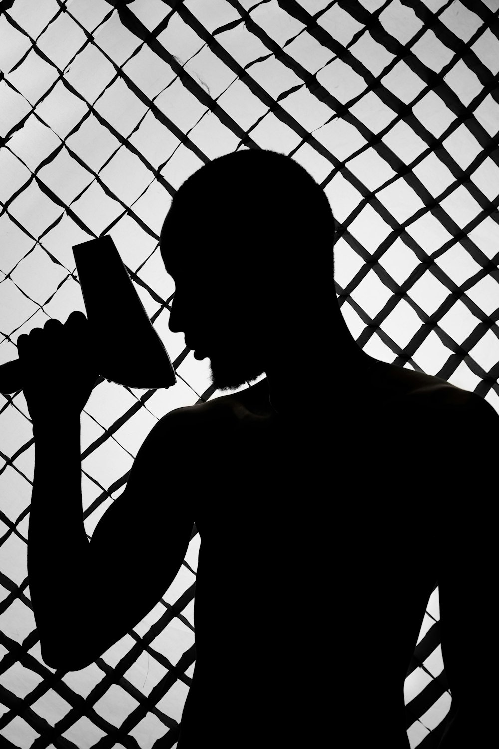 silhouette of man holding smartphone