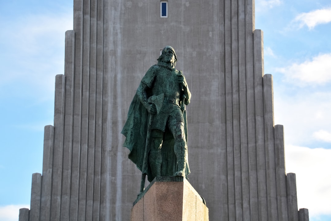 statue of man in green coat