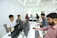 Professional team collaborating on computers in a modern office environment.