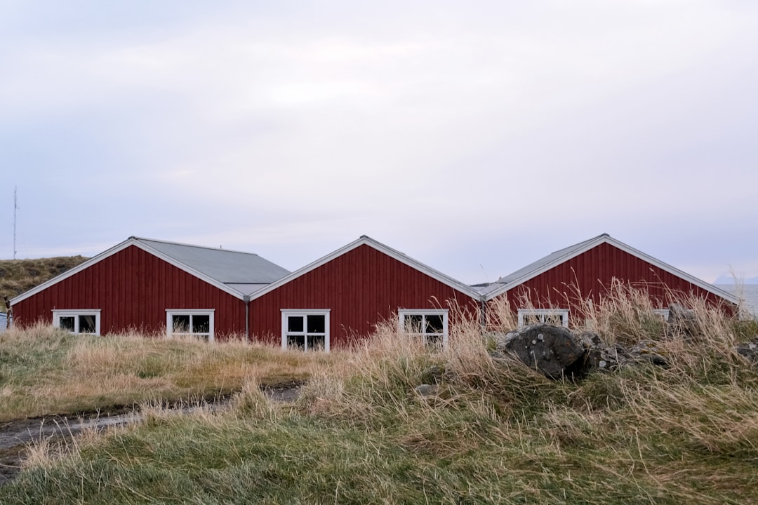 red and white barn house under white clouds