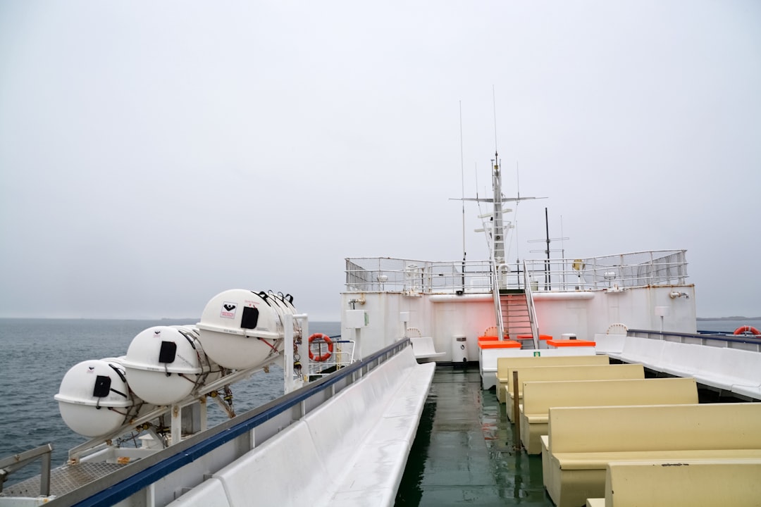 white and red ship on dock during daytime