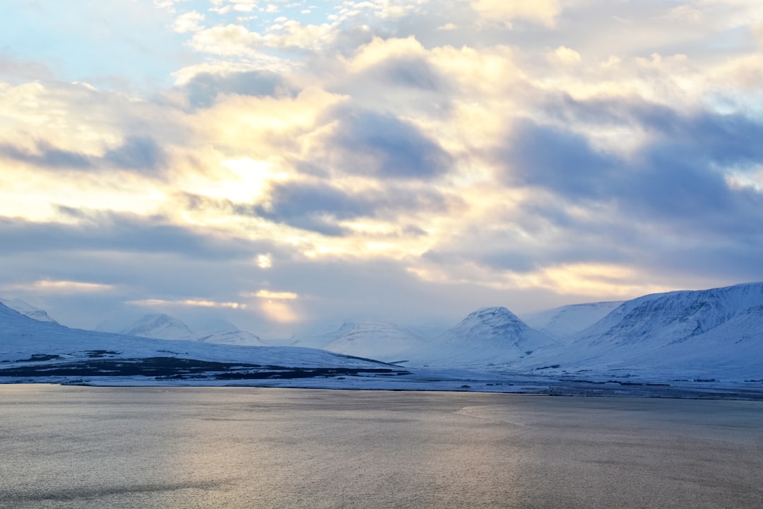 snow covered mountain under cloudy sky during daytime