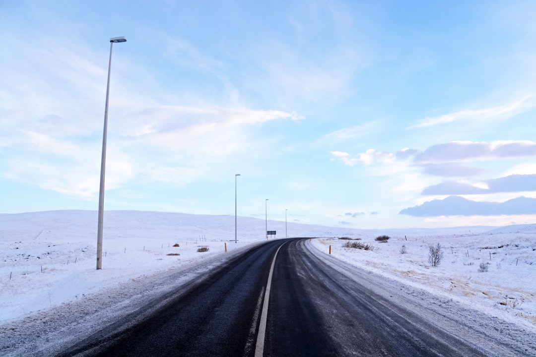 black asphalt road covered with snow during daytime