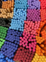 A colorful display of various padbergpen models arranged neatly on a store shelf.