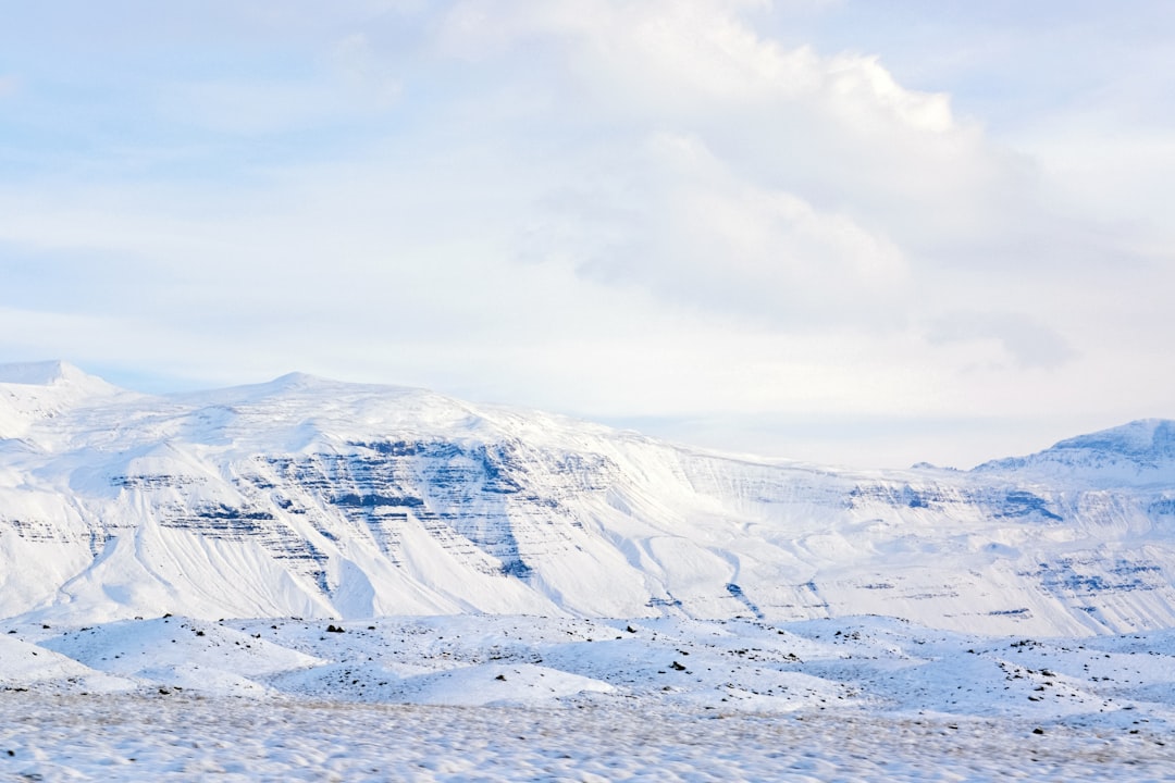 snow covered mountain under cloudy sky during daytime